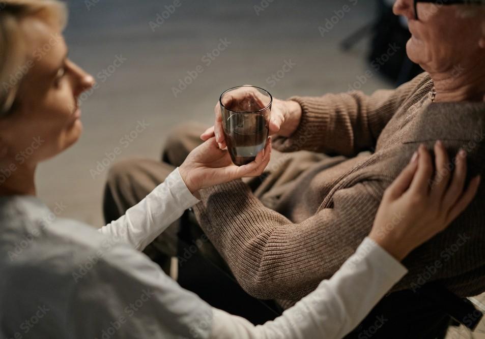 Clinician speaking with an older adult (senior psychiatry / PMHNP setting)